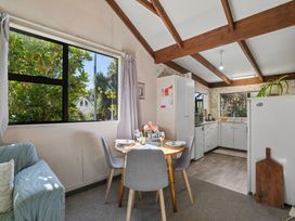 A kitchen with dining table and sofa at Wanaka Holiday Home in Wanaka