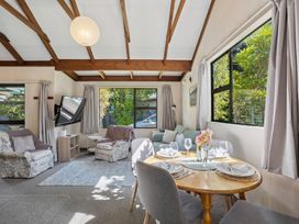 A living room with a dining table and sofa at Wanaka Holiday Home in Wanaka