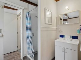 A bathroom with a shower and sink at Wanaka Holiday Home in Wanaka