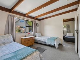 A bedroom with two beds and a window at Wanaka Holiday Home in Wanaka