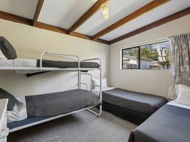 A bedroom with a bunk bed and single bed at Wanaka Holiday Home in Wanaka