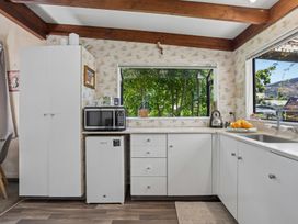 A kitchen with appliances and a window at Wanaka Holiday Home in Wanaka