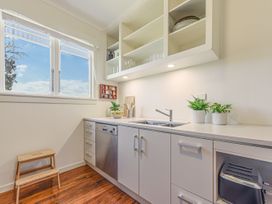A kitchen with a sink and plants at Kettle House - Upper Moutere Holiday Home