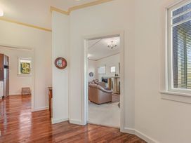 A hallway leading to a living room and kitchen at Kettle House - Upper Moutere Holiday Home