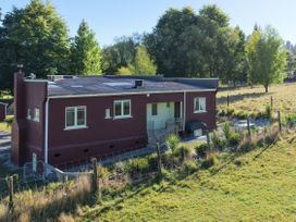 An exterior view of a house with yard at Kettle House - Upper Moutere Holiday Home