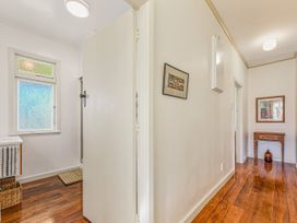 A hallway with a table and artwork at Kettle House - Upper Moutere Holiday Home