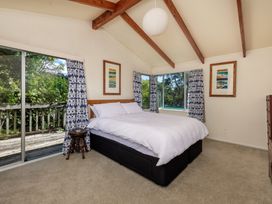 A bedroom with a bed and a window at Parekura Bay in Hikurangi