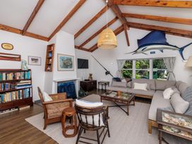 A living room with a coffee table and large sofa at Parekura Bay Hikurangi