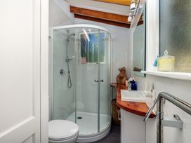 A bathroom with a shower, toilet, and sink at Parekura Bay in Hikurangi
