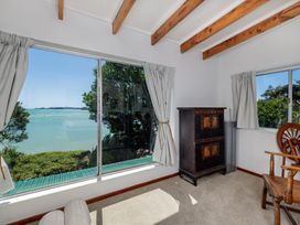 A living room with a view of the water at Parekura Bay, Hikurangi