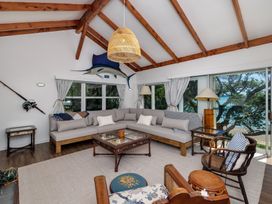 A living room with a sofa and coffee table at Parekura Bay Hikurangi