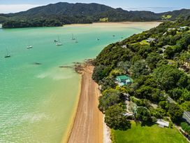 An aerial view of a beach and boats at Parekura Bay in Hikurangi