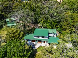 An aerial view of a house surrounded by trees at Parekura Bay in Hikurangi