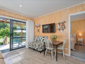 A living room with a sofa and table at River Cottage - Whitianga Holiday Home in Whitianga