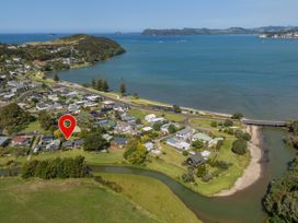 An aerial view of a residential area near the water at River Cottage - Whitianga Holiday Home, Whitianga
