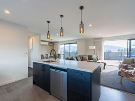 A kitchen with an island and dishwasher at Oraka Scenery - Te Anau Holiday Home Te Anau
