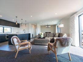 A living room with a sofa and chairs at Oraka Scenery - Te Anau Holiday Home in Te Anau