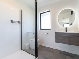 A bathroom with a shower and toilet at Oraka Scenery - Te Anau Holiday Home Te Anau