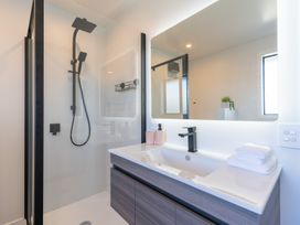 A bathroom with a shower and wash basin at Oraka Scenery - Te Anau Holiday Home, Te Anau