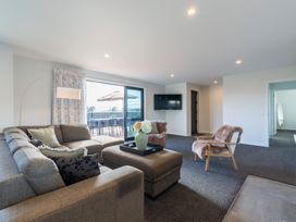 A living room with a sofa and coffee table at Oraka Scenery - Te Anau Holiday Home, Te Anau