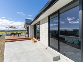 An outdoor area with patio furniture and a grill at Oraka Scenery - Te Anau Holiday Home in Te Anau