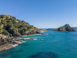 A coastal view with hills and islands at Opito Bay Holiday Home in Opito Bay