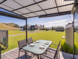 An outdoor dining table with plates at Opito Bay Holiday Home in Opito Bay