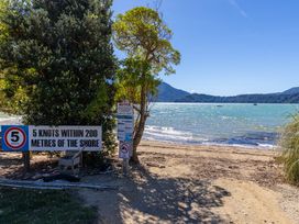 A sign indicating speed limits near the shore at Nature's Luxe - Moetapu Bay Holiday Home, Picton