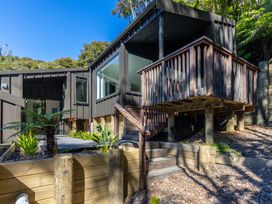 An outdoor view of a house with a deck and stairs at Nature's Luxe - Moetapu Bay Holiday Home, Picton