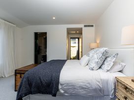 A bedroom with a bed and chest at Nature's Luxe - Moetapu Bay Holiday Home, Picton
