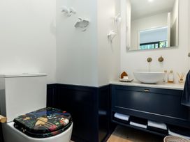 A bathroom with a toilet and sink at Nature's Luxe - Moetapu Bay Holiday Home, Picton