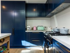 A kitchen with cabinets and appliances at Nature's Luxe - Moetapu Bay Holiday Home, Picton