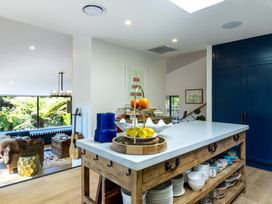 A kitchen with a wooden island and fruit bowl at Nature's Luxe - Moetapu Bay Holiday Home Picton