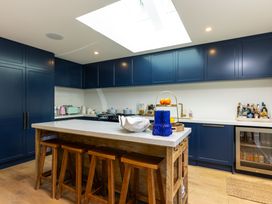 A kitchen with blue cabinets and a countertop island at Nature's Luxe - Moetapu Bay Holiday Home Picton