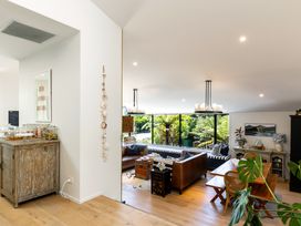 A living room with a sofa and table at Nature's Luxe - Moetapu Bay Holiday Home, Picton