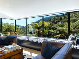 A living room with a sofa and a coffee table at Nature's Luxe - Moetapu Bay Holiday Home, Picton
