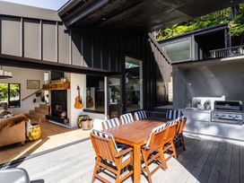 An outdoor dining area with table and chairs at Nature's Luxe - Moetapu Bay Holiday Home, Picton