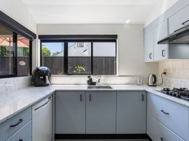 A kitchen with a sink and appliances at Mount Maunganui