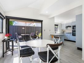 A kitchen with a table and chairs at Mount Maunganui