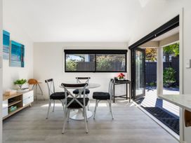 A dining room with a table and chairs at Mount Maunganui