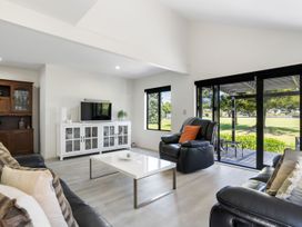 A living room with a sofa and television at Mount Maunganui