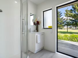 A bathroom with a sink and shower at Mount Maunganui