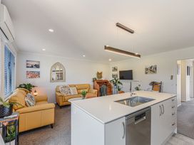 A living room with a kitchen island and sofa at Nelson in Richmond