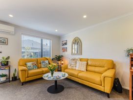 A living room with yellow sofas and a coffee table at Nelson in Richmond