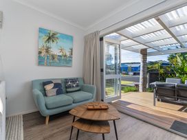 A living room with a sofa and coffee table at Ocean Haven - Whangamata Holiday home, Whangamata