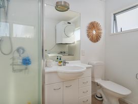 A bathroom with a shower, sink, and toilet at Ocean Haven - Whangamata Holiday home Whangamata