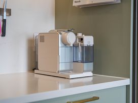 A coffee machine on a counter in a kitchen at Camelot - Lake Taupo Holiday Home Turangi