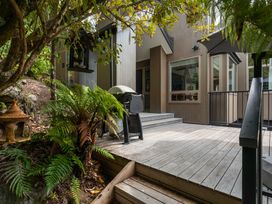 An outdoor area with a grill and stairs at Camelot - Lake Taupo Holiday Home in Turangi