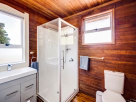 A bathroom with a shower, sink, and toilet at Pacific Vista - Hawkes Bay, Havelock North