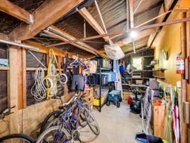 A garage with bicycles and storage bins at Pacific Vista - Hawkes Bay in Havelock North